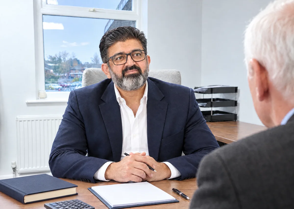 Furqan Ahmad seated at his desk during a conversation